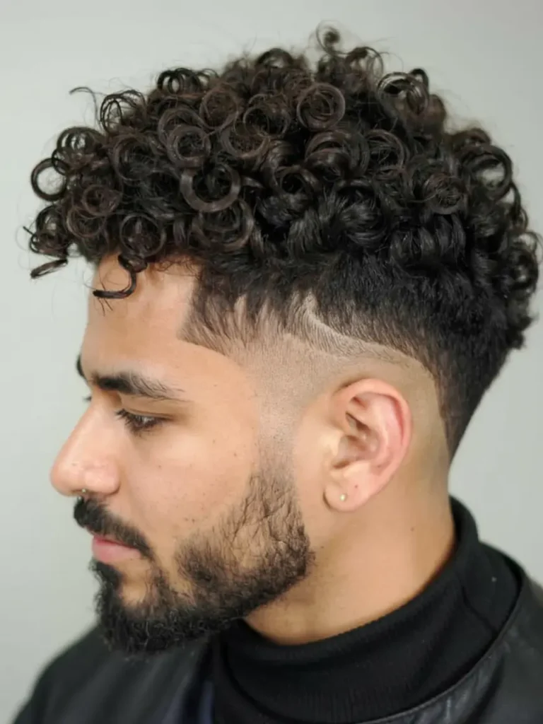 #11. Defined Curly Top with Skin Fade & Razor Detail