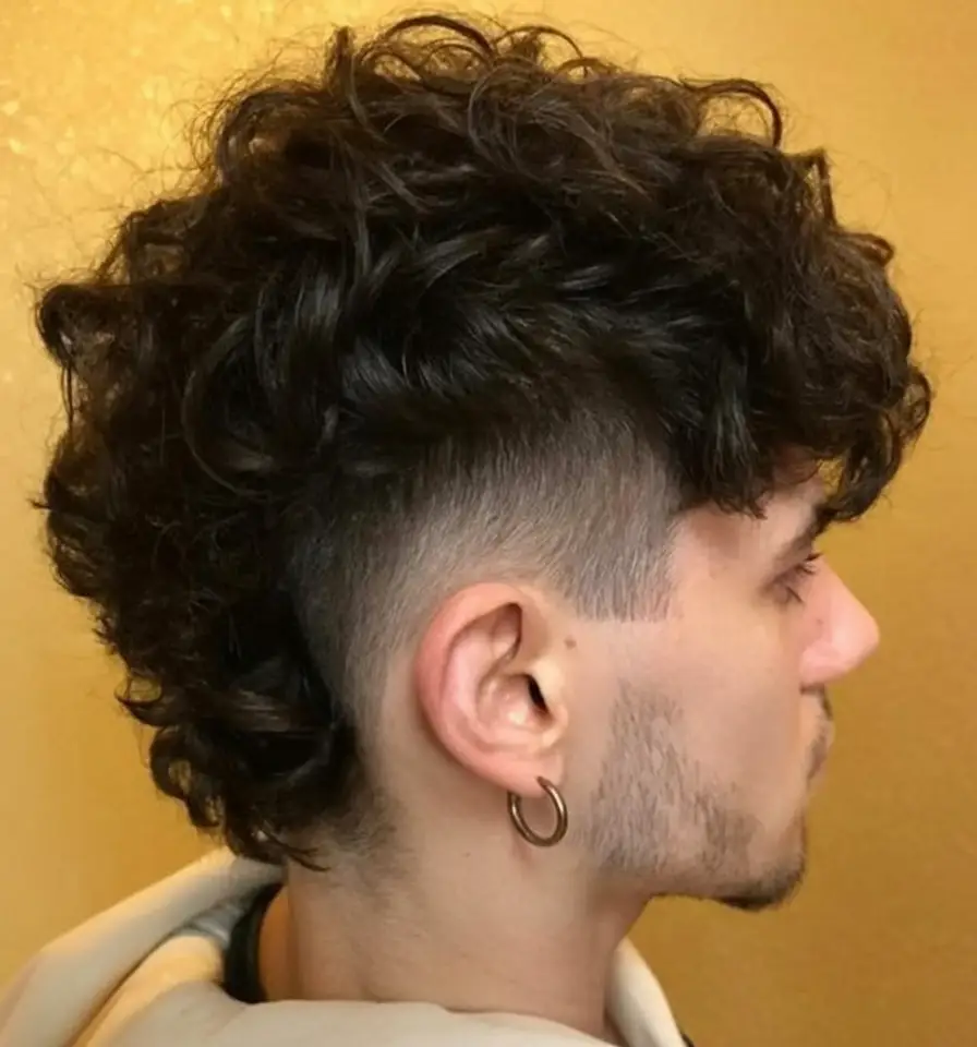#13. Voluminous Curly Mohawk with Skin Fade
